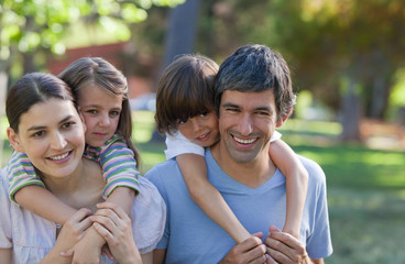 Canvas Print - Parents giving their children piggyback ride