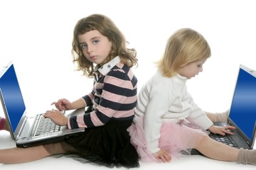 two little girls sister with computer laptops