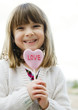 © BCFC - Adorable smiling little girl holding lollypop