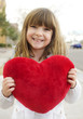 © BCFC - Happy smiling little child holding a heart cushion
