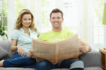 Canvas Print - Happy couple reading news