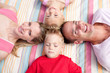 © WavebreakMediaMicro - Cheerful family sleeping lying on the grass