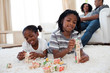 © WavebreakMediaMicro - Adorable brother and sister playing alphabetic cubes