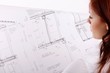 woman with house construction plan (focus on plan)