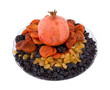 Pomegranate, raisins, dried apricots, prunes on a plate
