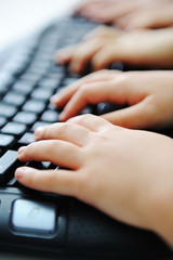 Many children hands typing