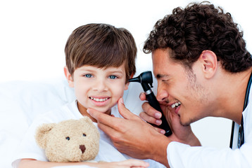 Smiling doctor examining patient's ears