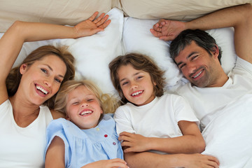 Wall Mural - Smiling family having fun in the bedroom