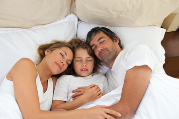 Wall Mural - Cute child and his parents sleeping together