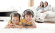 © WavebreakMediaMicro - Adorable siblings listening music with headphones