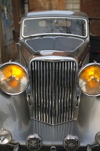 Car Vintage, Old Jaguar In Silver Color, Yellow Headlights