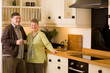 © jamstockfoto - Senior couple portrait in modern designer kitchen