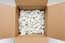 A Cardboard Box With Packing Foam Pellets Top View..