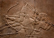 Ancient relief of assyrian warriors fighting in the war