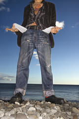 Young Man at Beach with Empty Pockets