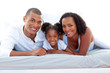 © WavebreakMediaMicro - Affectionate parents and their daughter smiling at the camera