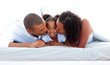 © WavebreakMediaMicro - Cheerful parents kissing their daughter