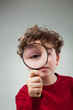 © Jacek Chabraszewski - Boy using magnifying glass