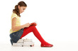© Monkey Business - Young Girl Sitting On Pile Of Books Reading