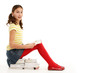 © Monkey Business - Young Girl Sitting On Pile Of Books Reading