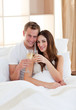 © WavebreakMediaMicro - Affectionate couple drinking champagne lying in bed