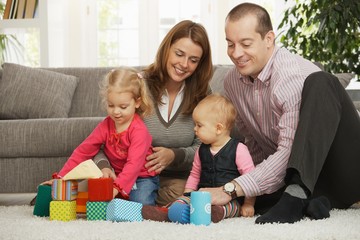 Happy family with baby and toddler