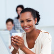 © WavebreakMediaMicro - Glowing businesswoman drinking a coffee at her desk
