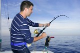 Angler Fisherman Fighting Big Fish Rod And Reel Stock Photo - Download  Image Now - 30-39 Years, 35-39 Years, Adult - iStock