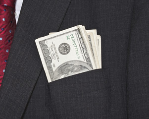 dollar bills in suit pocket