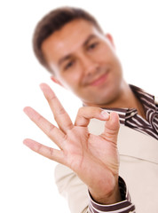 Close-up of a businessman making OK sign against a white backgro