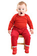 Shocked baby dressed in red looking at camera isolated on white
