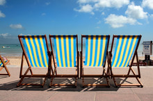 Row Of Colourful Deckchairs On Weymouth Beach