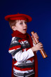 Little boy in red scarf and beret with a spyglass