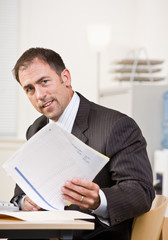 Wall Mural - Businessman reviewing paperwork