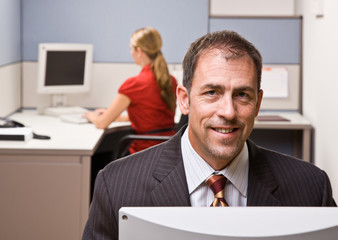 Wall Mural - Businessman sitting at desk smiling