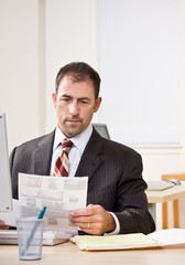 Wall Mural - Businessman reviewing paperwork