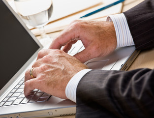 Canvas Print - Close up of businessman typing on laptop