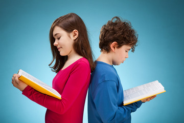 Girl and boy reading book