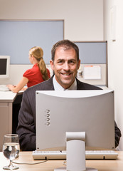 Wall Mural - Businessman typing on computer at desk