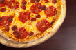 © lixai - Pepperoni pizza on a wooden plate