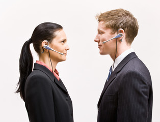 Wall Mural - Business people in headsets standing face to face