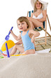 © CandyBox Images - Beach - Mother with child playing with toys in sand