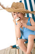 © CandyBox Images - Beach - Little girl on deck-chair with hat and ice-cream