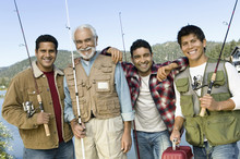 Middle-aged Man With Three Sons Holding Fishing Rods Smiling (portrait)