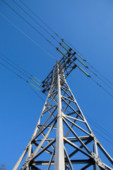 Metal electric pole on a blue sky background