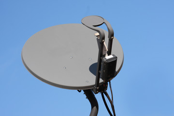 Satellite dish with blue sky background