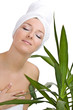 Caucasian woman with towel on head and green plant
