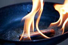 Sausage In The Flame In Frying Pan