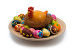 Lots of easter eggs and hen in nest on wooden plate