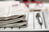 Fototapeta  - Financial Newspapers on laptop keyboard